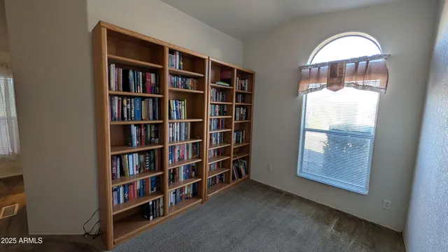 a view of a livingroom with furniture and staircase