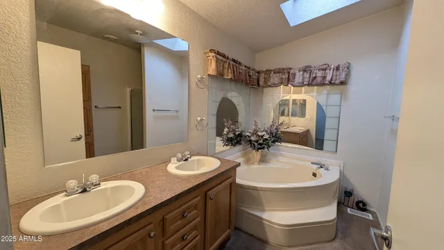 a bathroom with a double vanity sink and a mirror