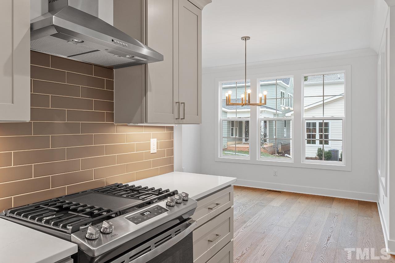 6502 Brecken Pnes Court Raleigh, NC 27612 - Photo 13 of 32 a kitchen with stove and cabinets