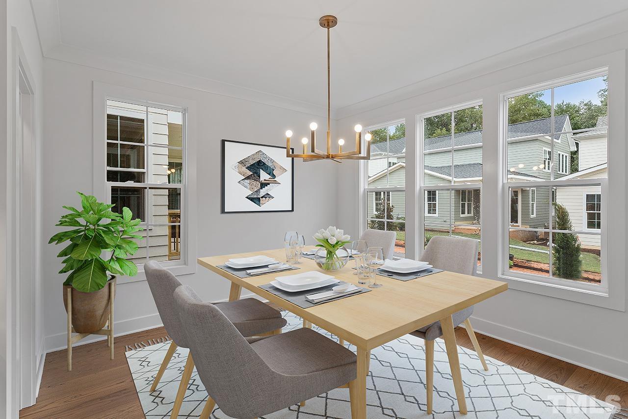 6502 Brecken Pnes Court Raleigh, NC 27612 - Photo 15 of 32 a view of a dining room with furniture window and wooden floor