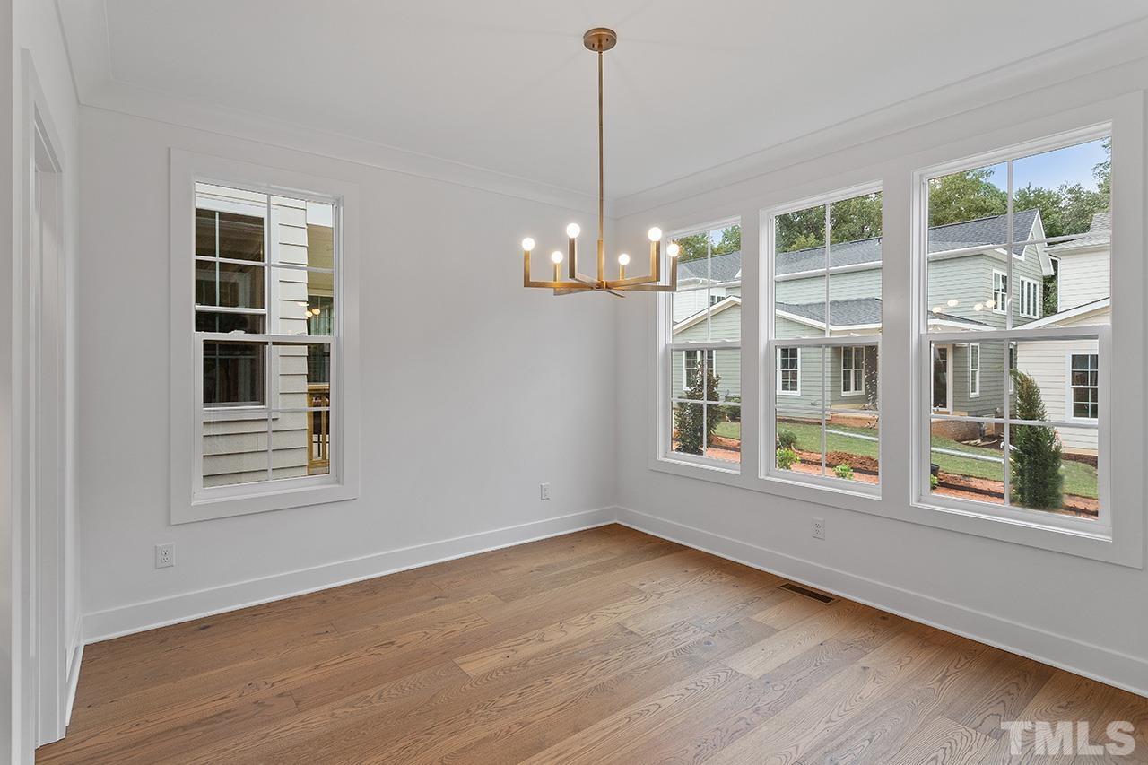 6502 Brecken Pnes Court Raleigh, NC 27612 - Photo 16 of 32 a view of an empty room with a window and wooden floor