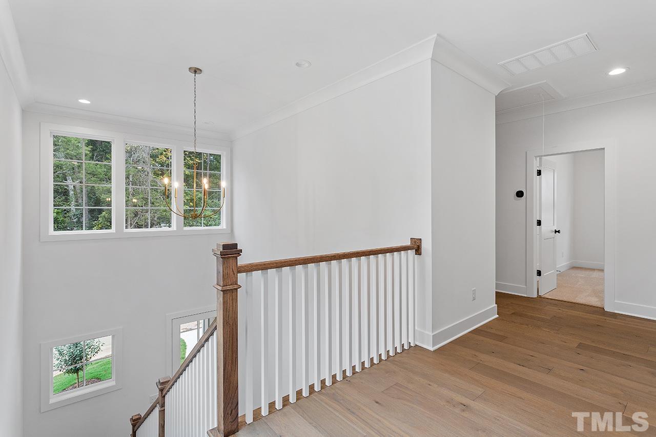 6502 Brecken Pnes Court Raleigh, NC 27612 - Photo 18 of 32 a view of an empty room with wooden floor and a window