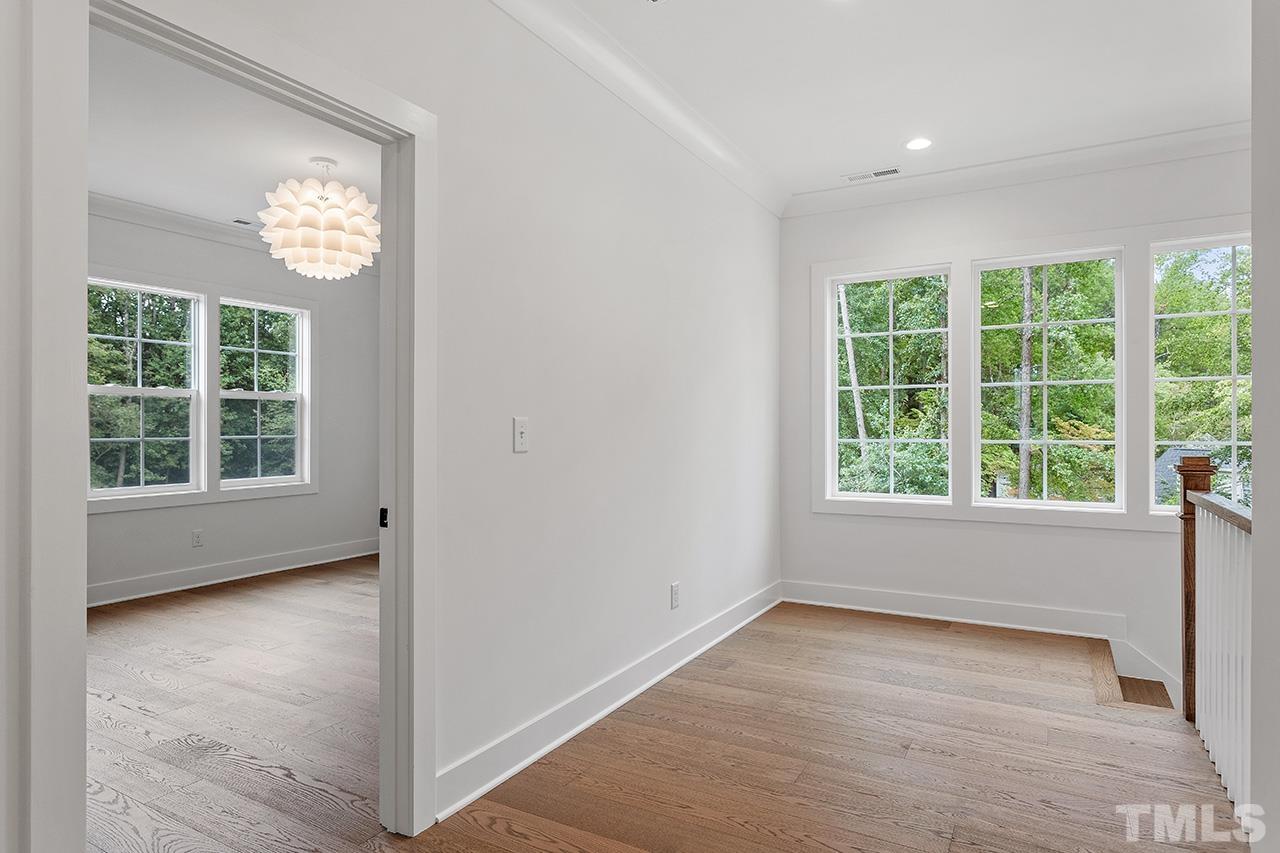 6502 Brecken Pnes Court Raleigh, NC 27612 - Photo 19 of 32 an empty room with wooden floor and windows