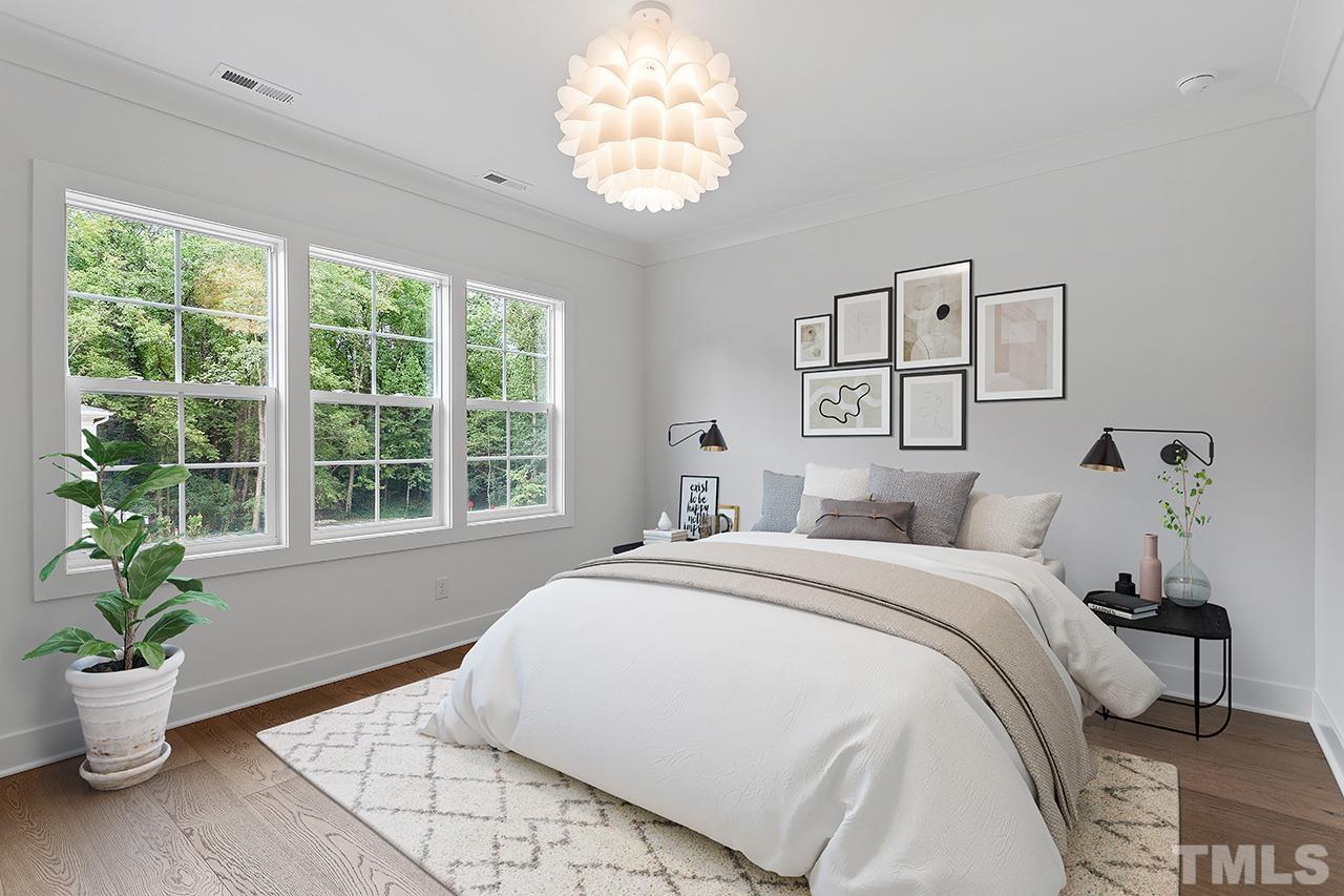 6502 Brecken Pnes Court Raleigh, NC 27612 - Photo 20 of 32 a spacious bedroom with a bed and a window
