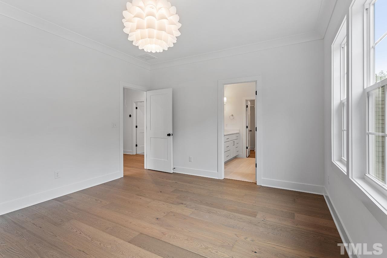 6502 Brecken Pnes Court Raleigh, NC 27612 - Photo 22 of 32 wooden floor in an empty room with a window