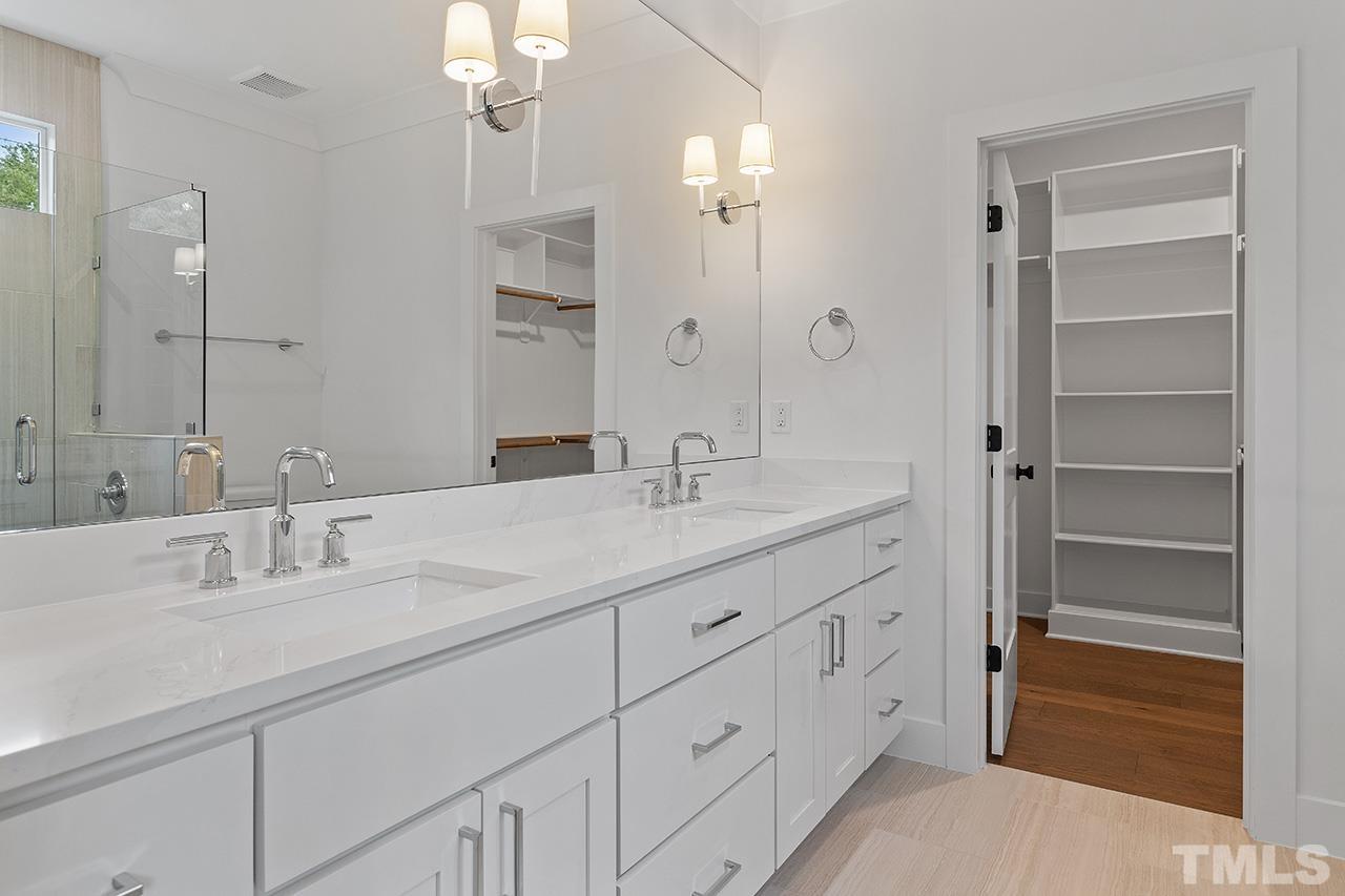 6502 Brecken Pnes Court Raleigh, NC 27612 - Photo 24 of 32 a bathroom with double vanity sinks and a mirror