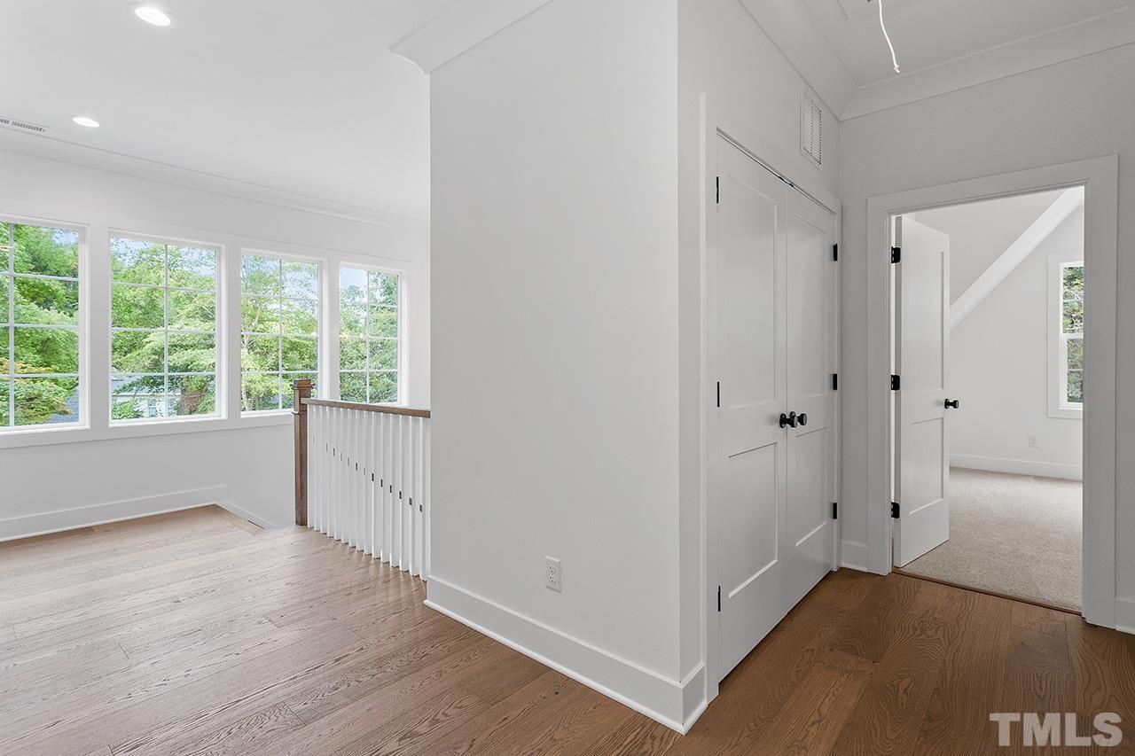 6502 Brecken Pnes Court Raleigh, NC 27612 - Photo 25 of 32 a view of an empty room with wooden floor and a window