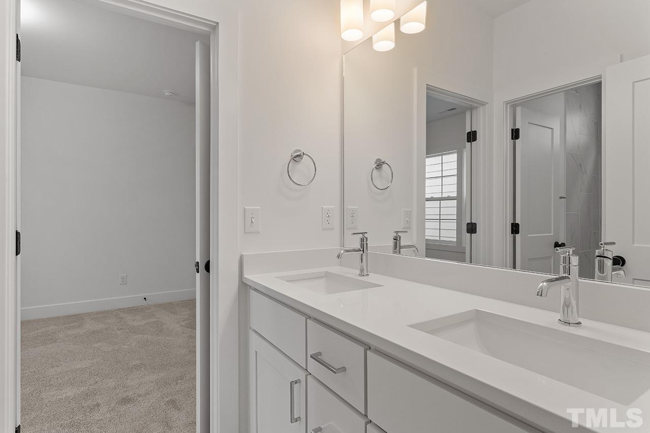 6502 Brecken Pnes Court Raleigh, NC 27612 - Photo 28 of 32 a bathroom with a sink and a mirror
