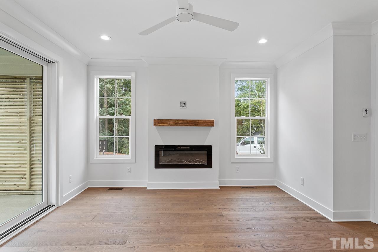 6502 Brecken Pnes Court Raleigh, NC 27612 - Photo 7 of 32 an empty room with windows and fireplace