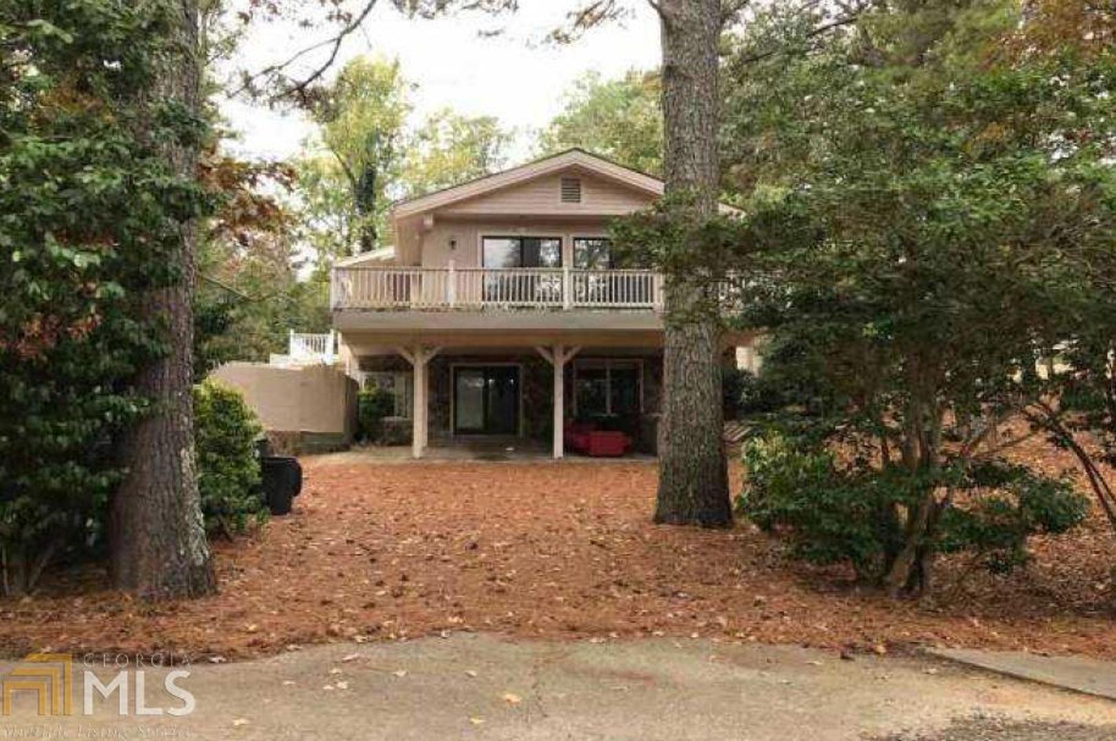 7411 Golfers Point Villa Rica, GA 30180 - Photo 1 of 1 a front view of a house with yard and trees