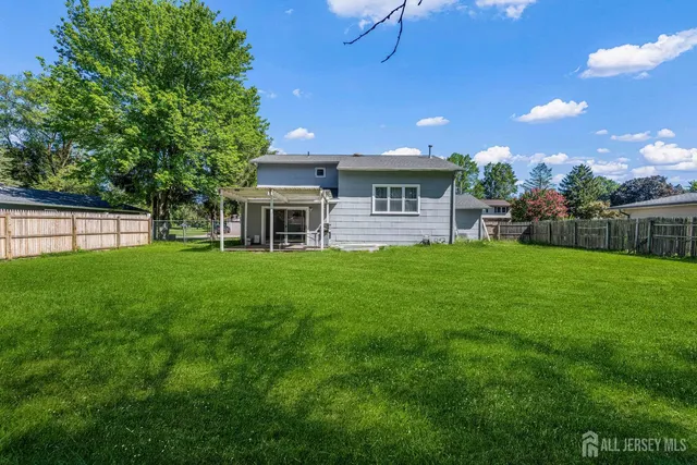 a view of a house with a yard and sitting area
