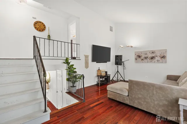 an aerial view of a swimming pool with lawn chairs and large trees