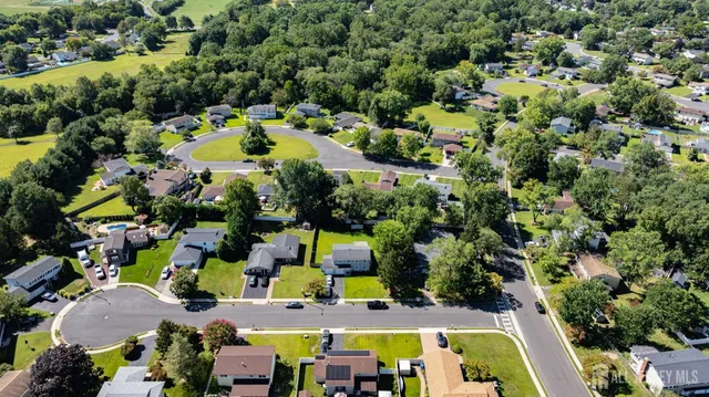 an aerial view of a house with a swimming pool yard and outdoor seating