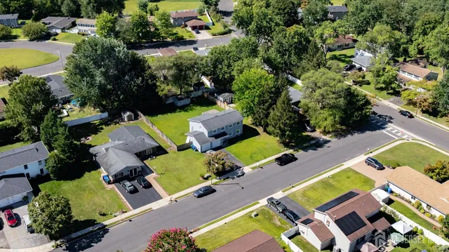 an aerial view of multiple houses with yard