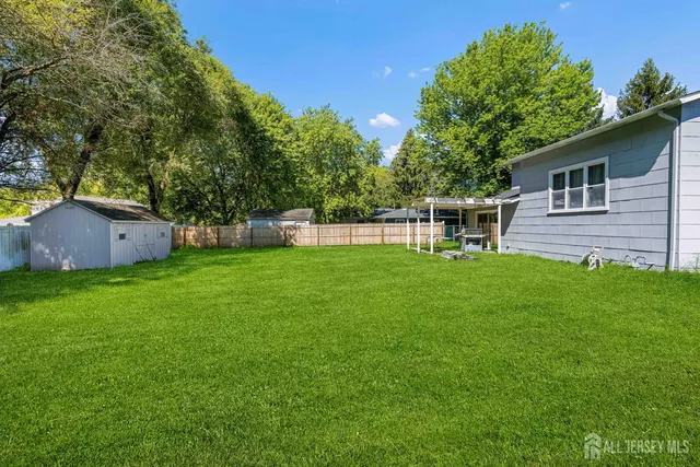 a backyard of a house with table and chairs