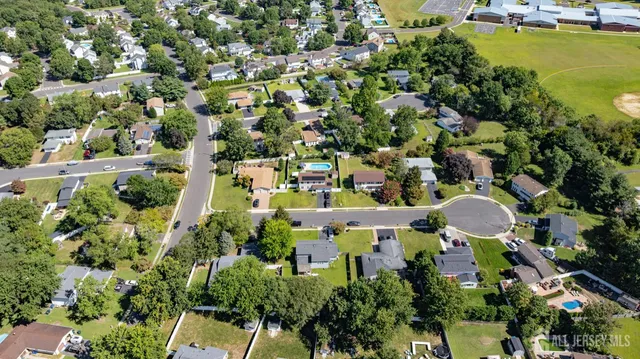 an aerial view of a house with yard swimming pool and outdoor seating