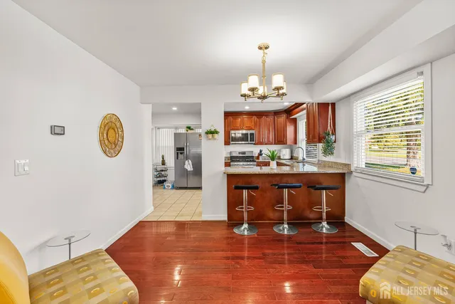 a view of living room with furniture and wooden floor