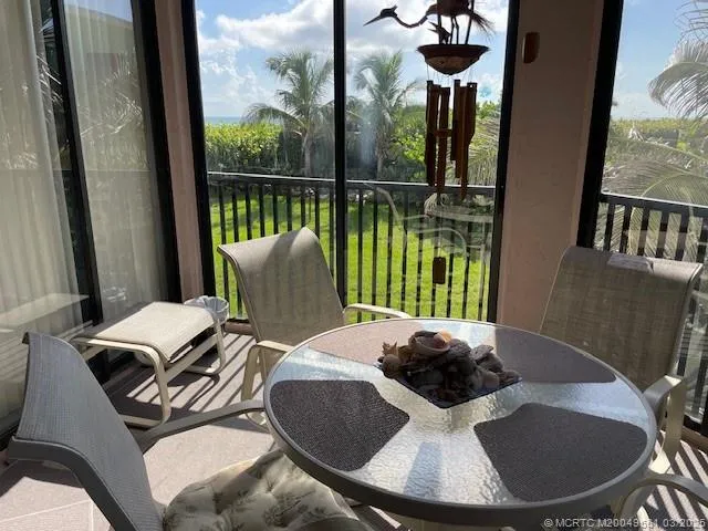 a table and chairs sitting on a balcony