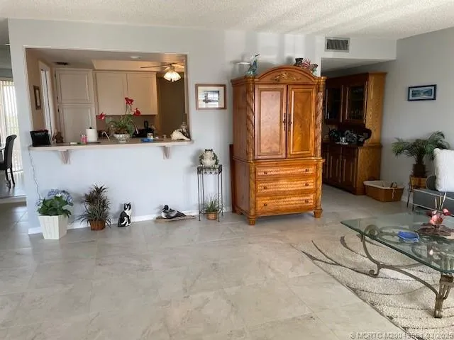 a view of room with furniture and a ceiling fan