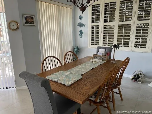 a view of a dining room with furniture and window