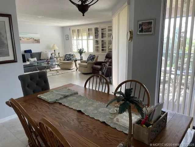 a view of a dining room with furniture window and outside view