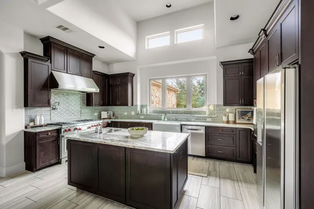 a kitchen with a stove sink and refrigerator