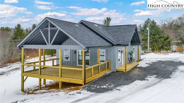 a view of a house with wooden walls and a floor to ceiling window