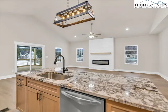 a kitchen with granite countertop a sink and a stove