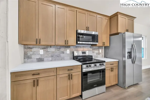 a kitchen with a stove microwave and refrigerator