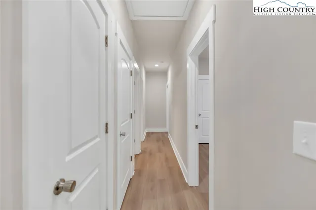 a view of a hallway with wooden floor