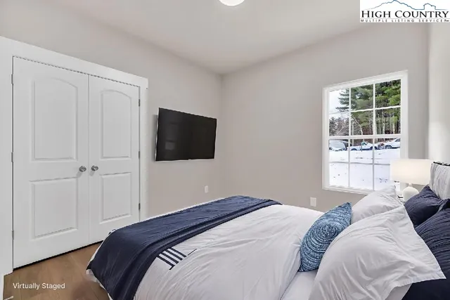 a bedroom with a bed and a window