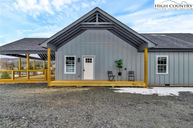 a view of a house with large windows and a yard