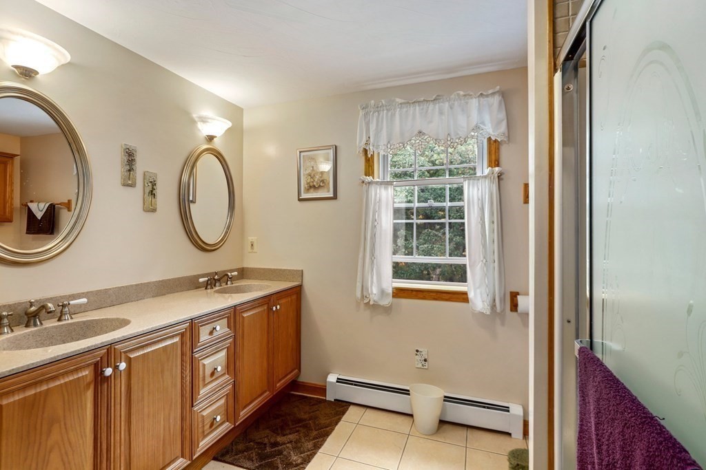 11 Easter Brook Road Lunenburg, MA 01462 - Photo 30 of 41 a bathroom with a granite countertop double vanity sink a mirror and a window
