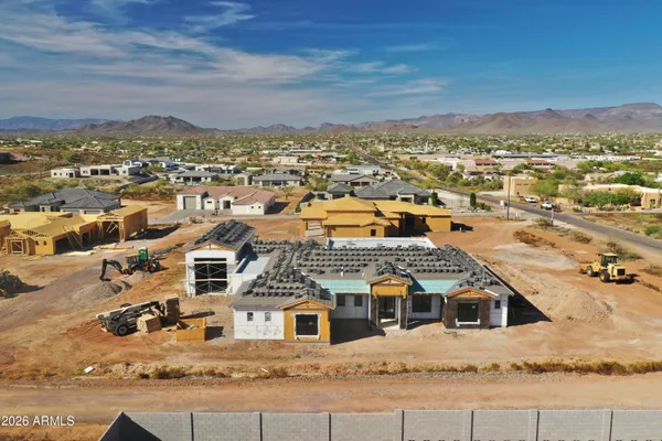 an aerial view of residential houses with a city view