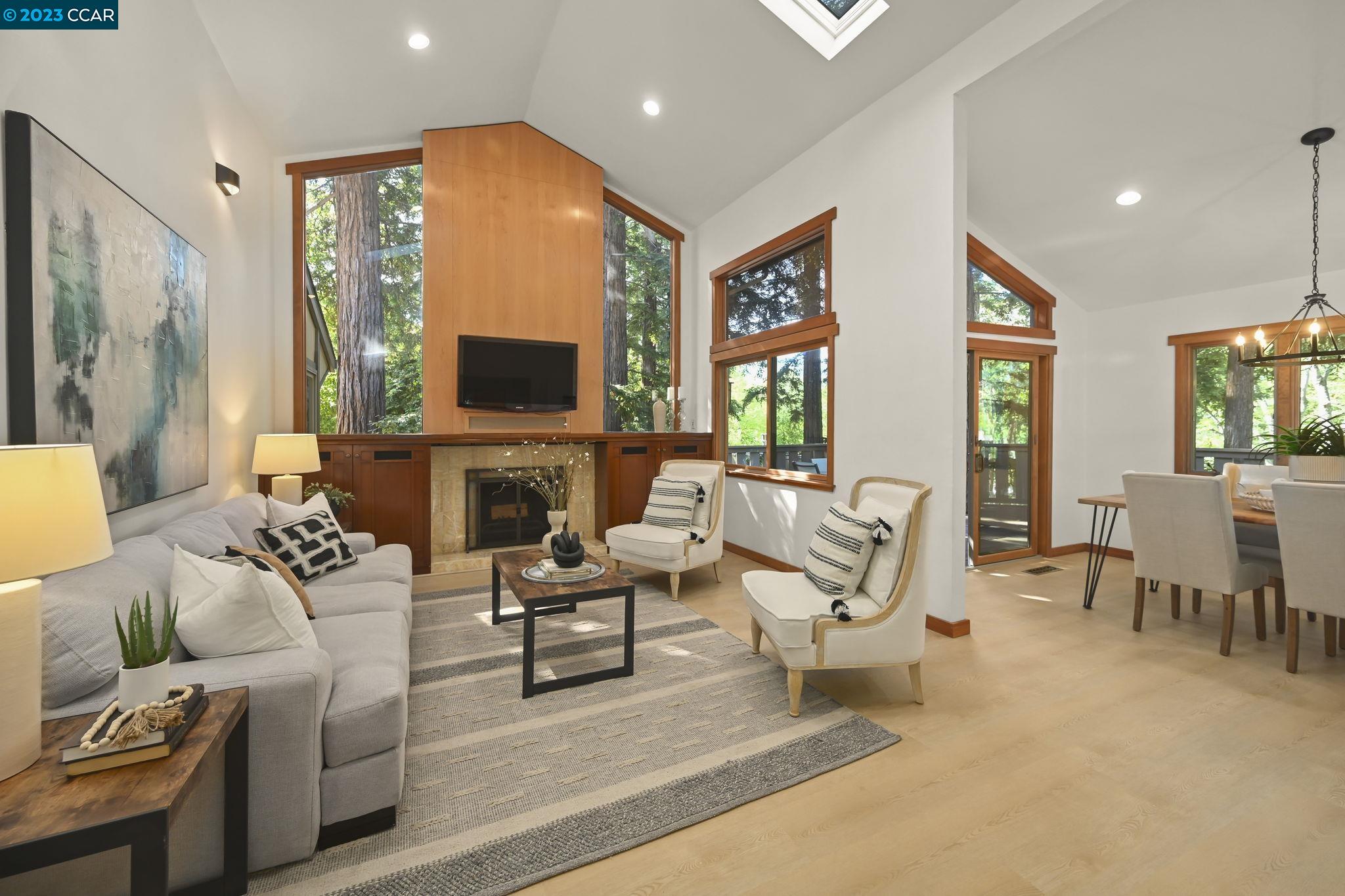 a living room with furniture a large window and a fireplace
