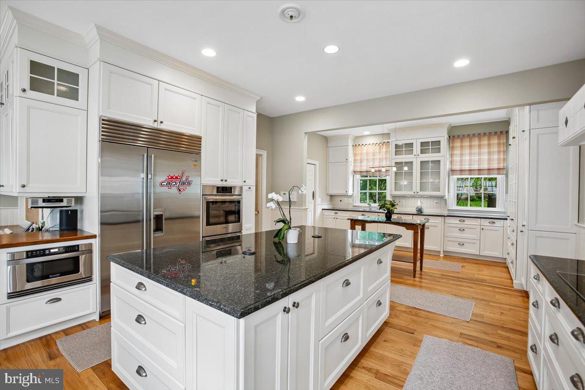 6809 Sorrel Street McLean, VA 22101 - Photo 14 of 101 a kitchen with stainless steel appliances granite countertop a sink stove and refrigerator
