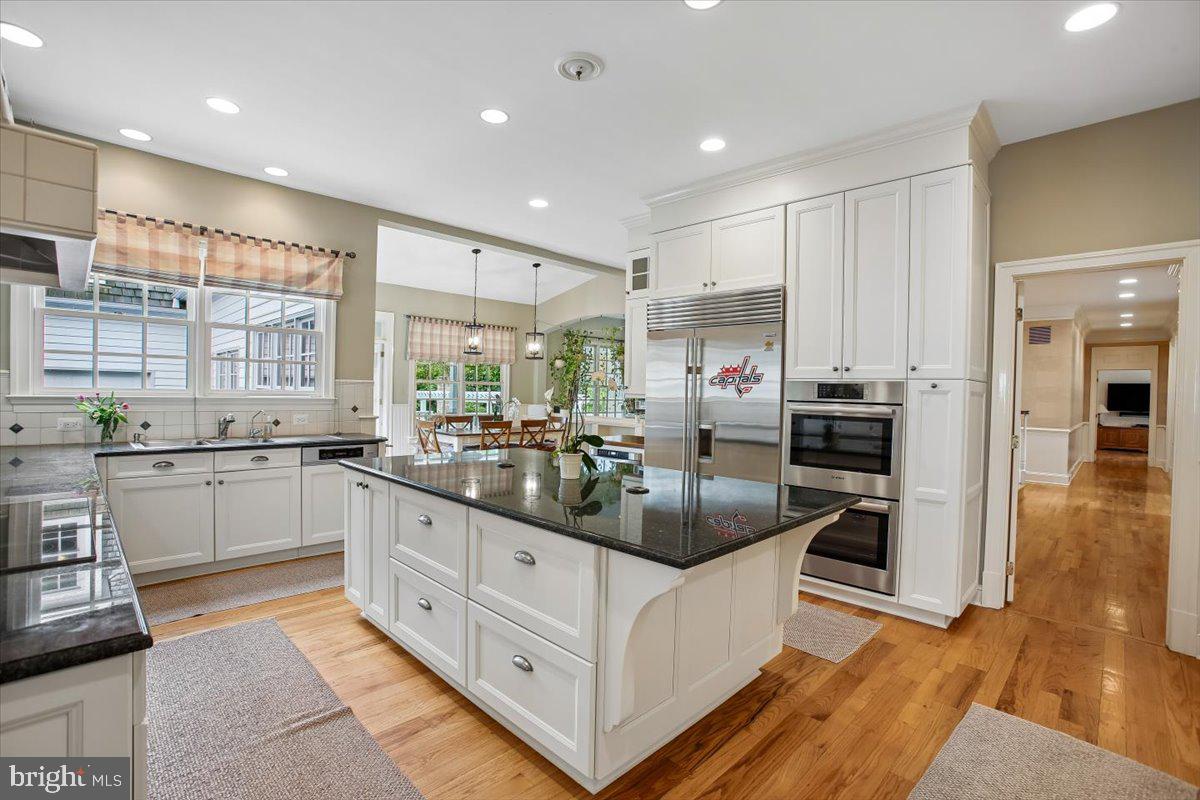 6809 Sorrel Street McLean, VA 22101 - Photo 15 of 101 a kitchen with stainless steel appliances kitchen island granite countertop a refrigerator and cabinets