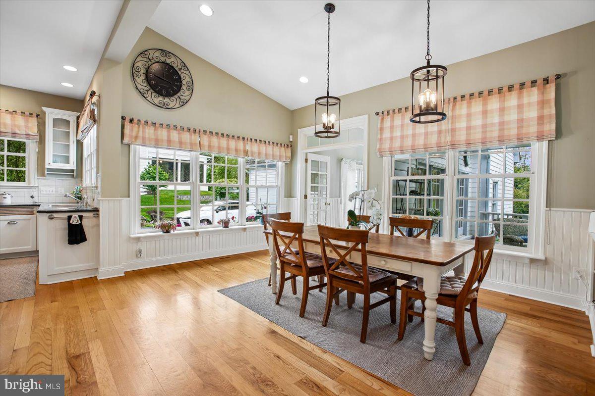 6809 Sorrel Street McLean, VA 22101 - Photo 20 of 101 a view of a dining room and livingroom with furniture wooden floor a chandelier