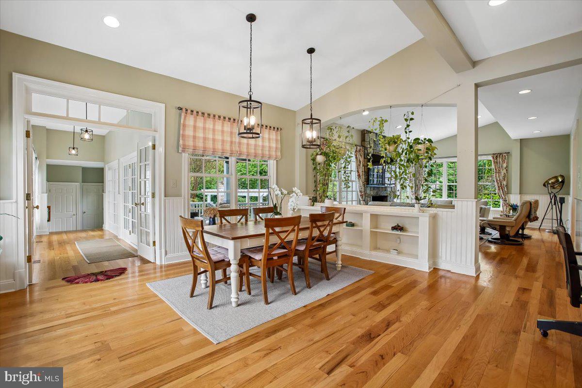 6809 Sorrel Street McLean, VA 22101 - Photo 21 of 101 a dining room with wooden floor a chandelier a wooden table and chairs