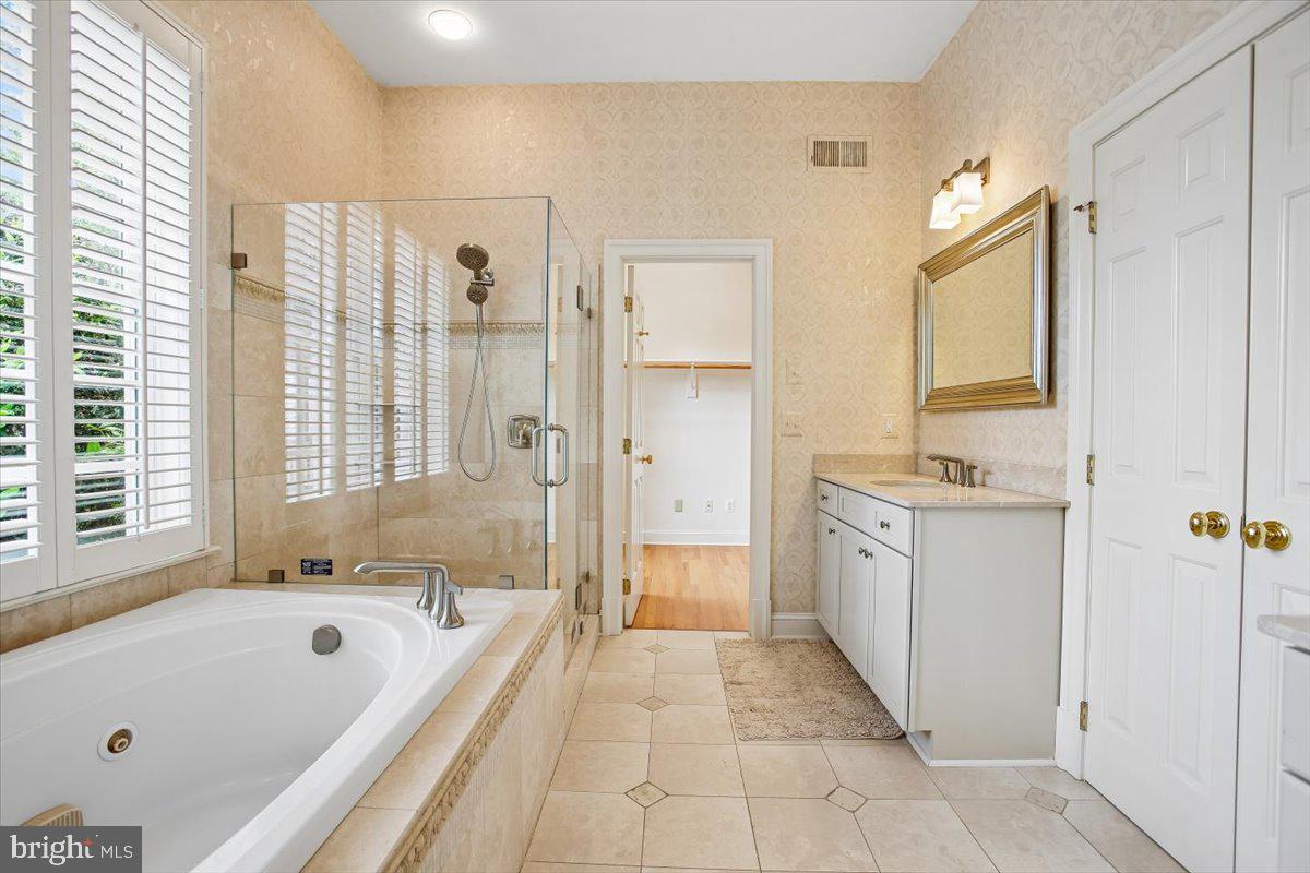 6809 Sorrel Street McLean, VA 22101 - Photo 30 of 101 a spacious bathroom with a tub sink shower and mirror