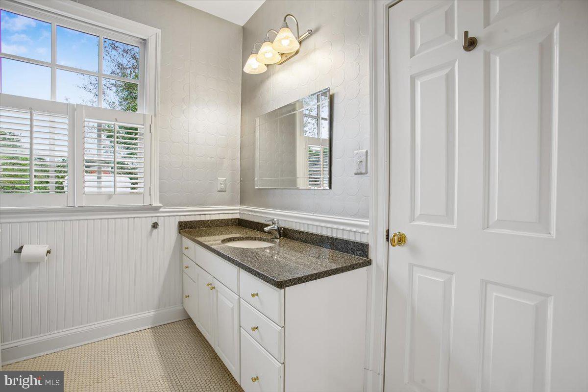 6809 Sorrel Street McLean, VA 22101 - Photo 50 of 101 a bathroom with a granite countertop sink and a mirror