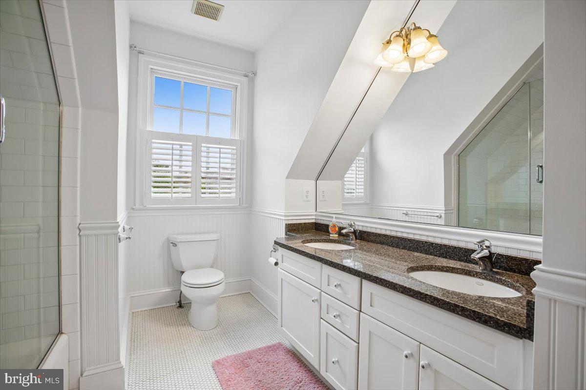 6809 Sorrel Street McLean, VA 22101 - Photo 56 of 101 a bathroom with a granite countertop sink a toilet and a mirror
