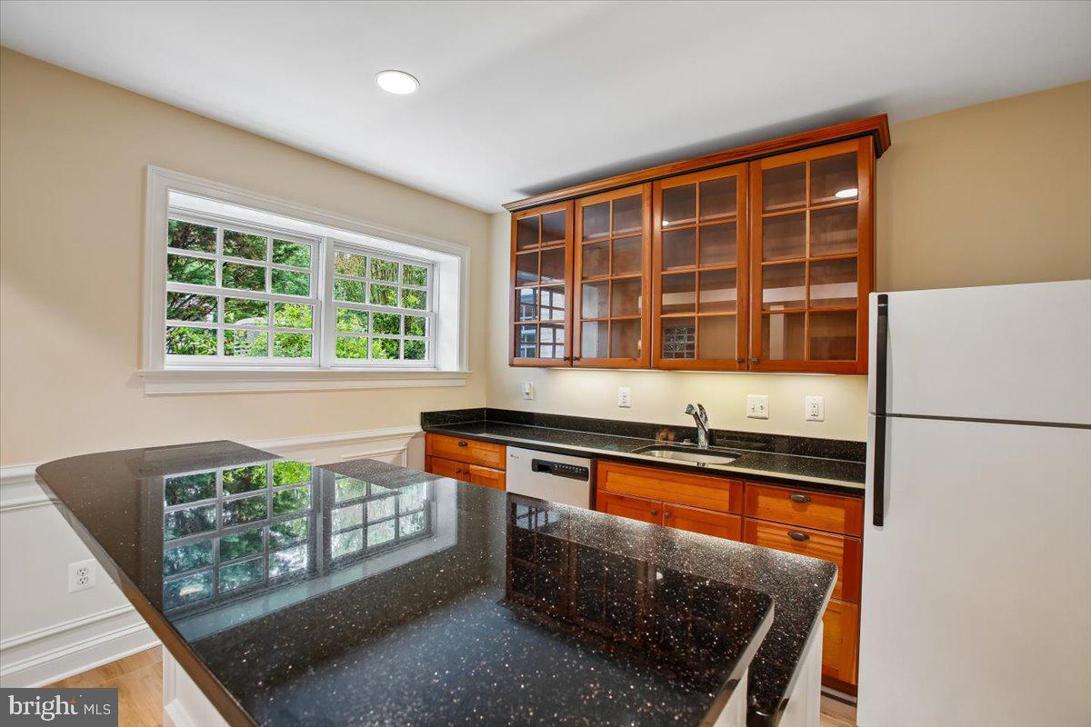 6809 Sorrel Street McLean, VA 22101 - Photo 67 of 101 a kitchen with stainless steel appliances granite countertop a stove a sink and a refrigerator