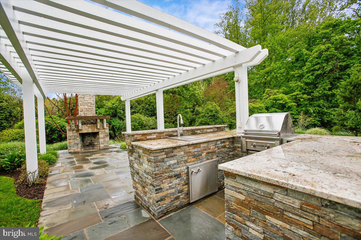 6809 Sorrel Street McLean, VA 22101 - Photo 79 of 101 a view of a patio with table and chairs potted plants with floor to ceiling window