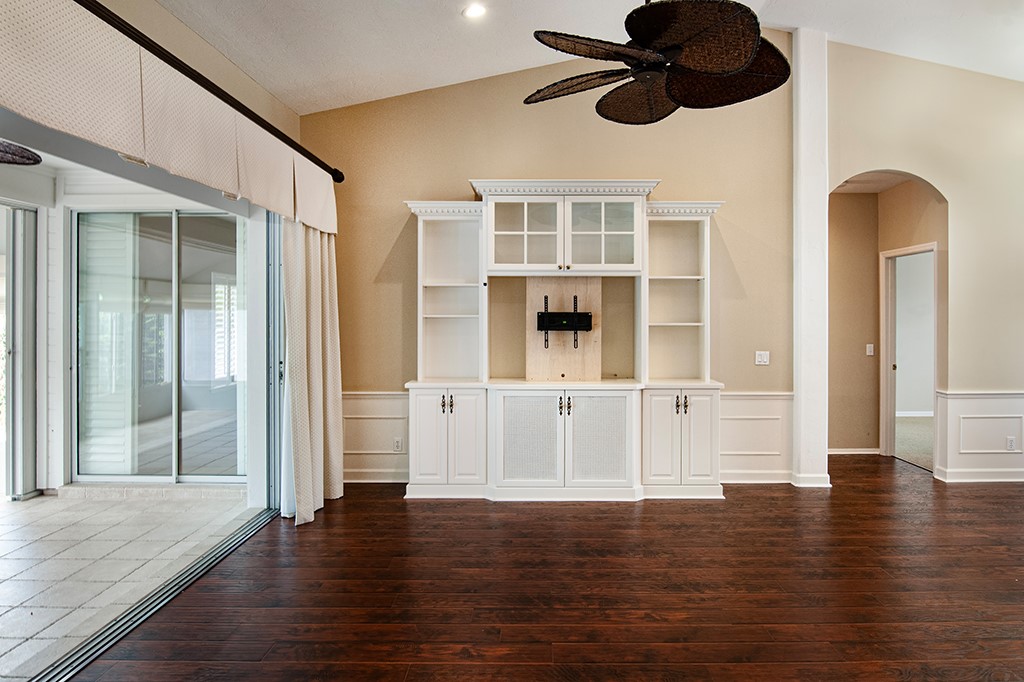 710 Timber Ridge Trail Southwest Vero Beach, FL 32962 - Photo 12 of 35 a view of an empty room with wooden floor and chandelier