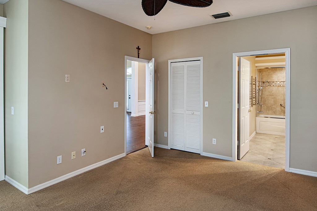 710 Timber Ridge Trail Southwest Vero Beach, FL 32962 - Photo 17 of 35 an empty room that has a glass door and painted walls