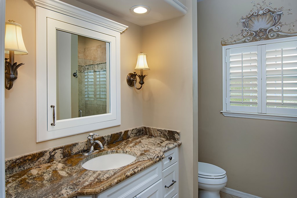 710 Timber Ridge Trail Southwest Vero Beach, FL 32962 - Photo 21 of 35 a bathroom with a granite countertop sink toilet and shower