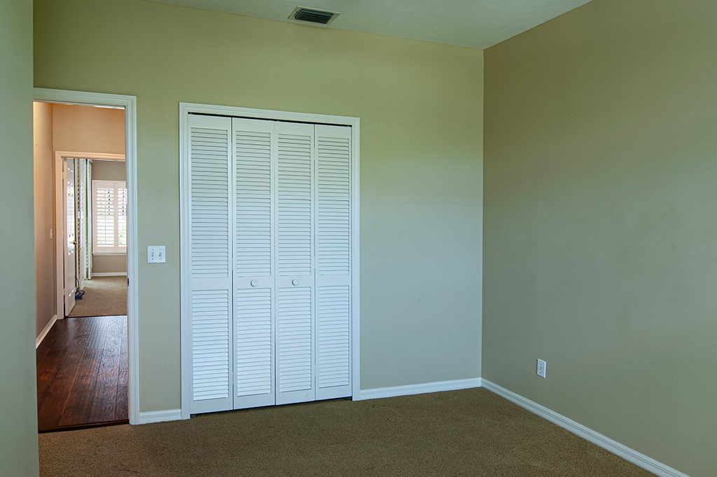 710 Timber Ridge Trail Southwest Vero Beach, FL 32962 - Photo 24 of 35 an empty room with wooden floor and windows