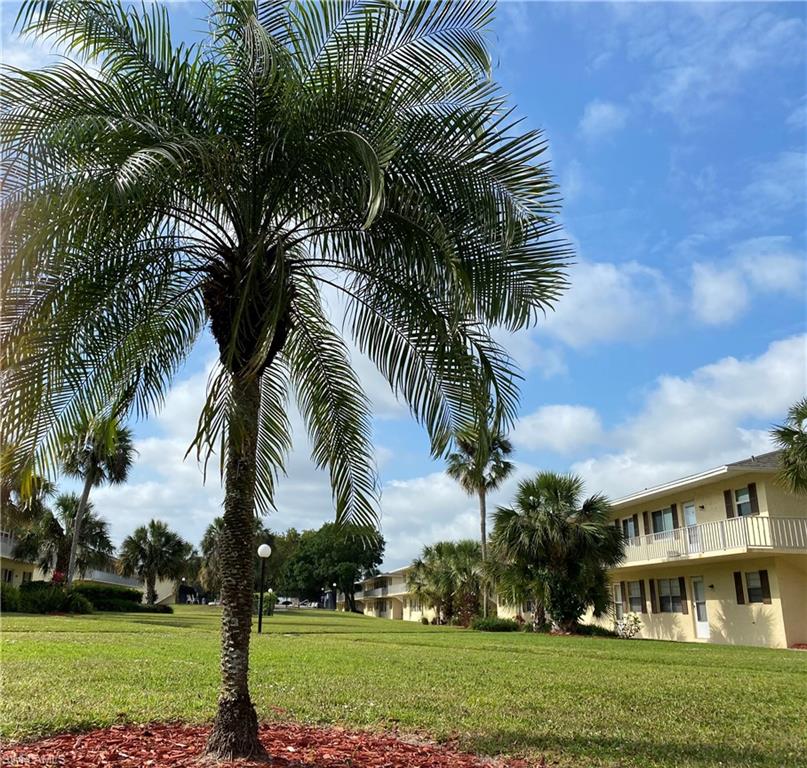 3325 Airport Road North, Unit S8 Naples, FL 34105 - Photo 1 of 3 a front view of a house with a garden