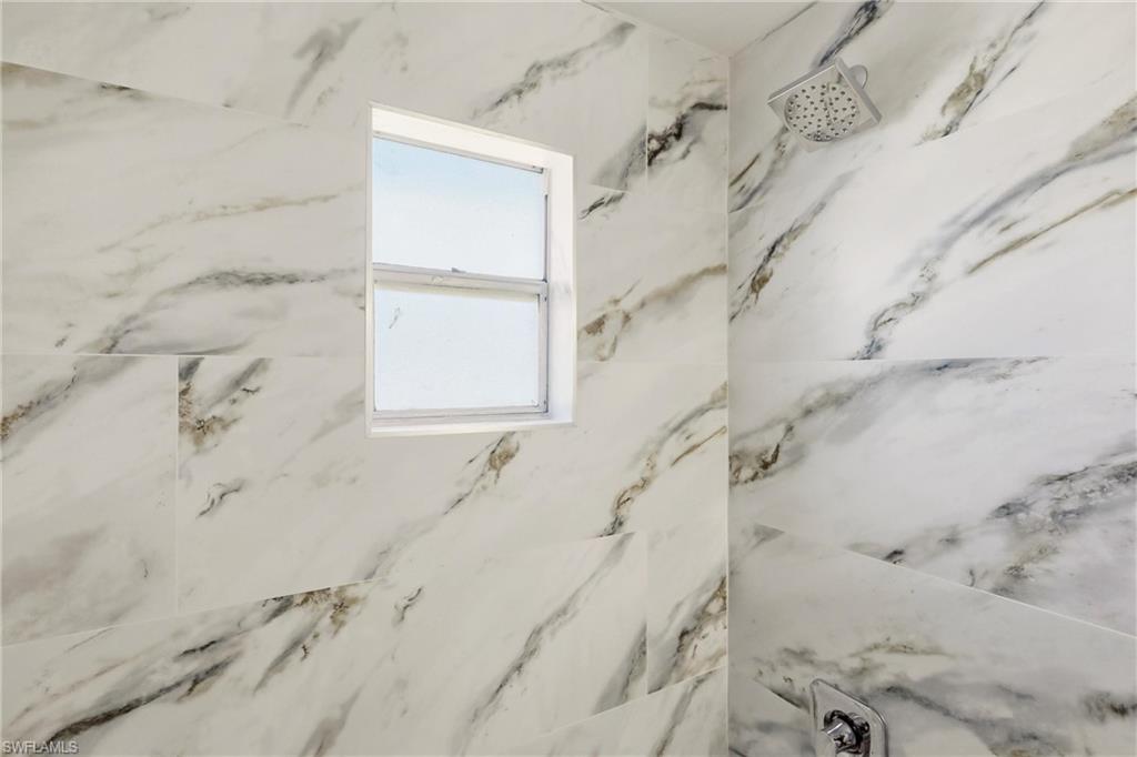 3325 Airport Road North, Unit S8 Naples, FL 34105 - Photo 16 of 33 a bathroom with a bathtub